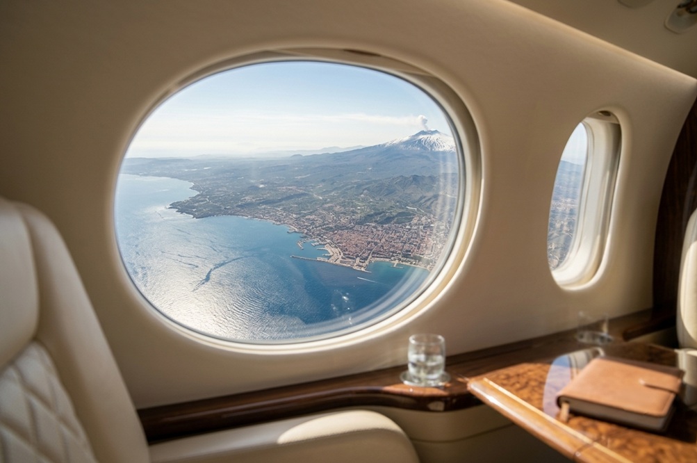 view of Sicily and Etna from a private jet window